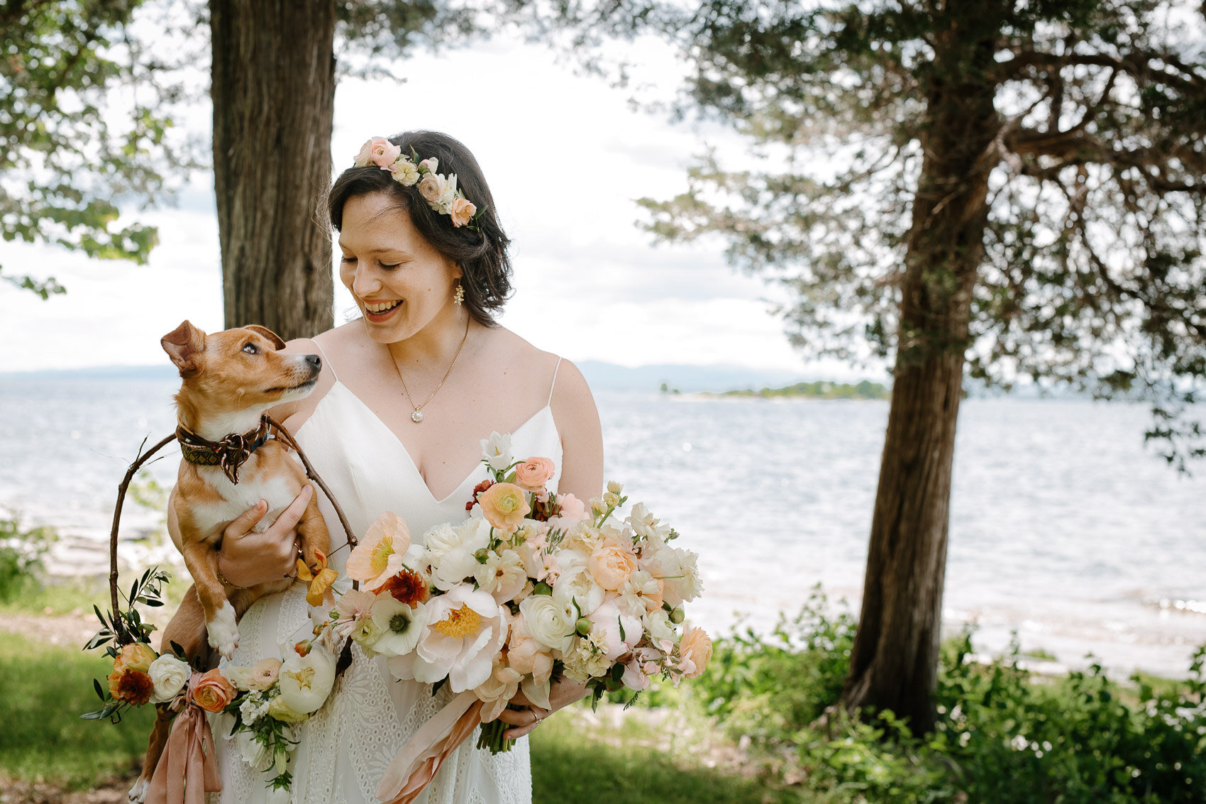 Bride holding her dog who has a GoPro on him