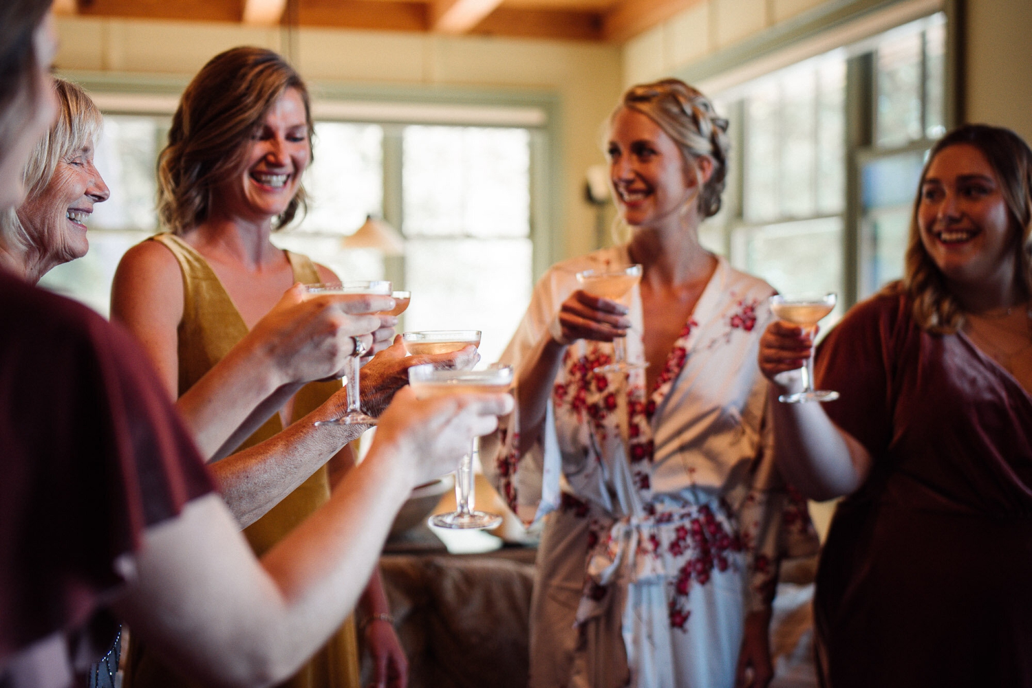 Bride and bridal party toasting before a wedding