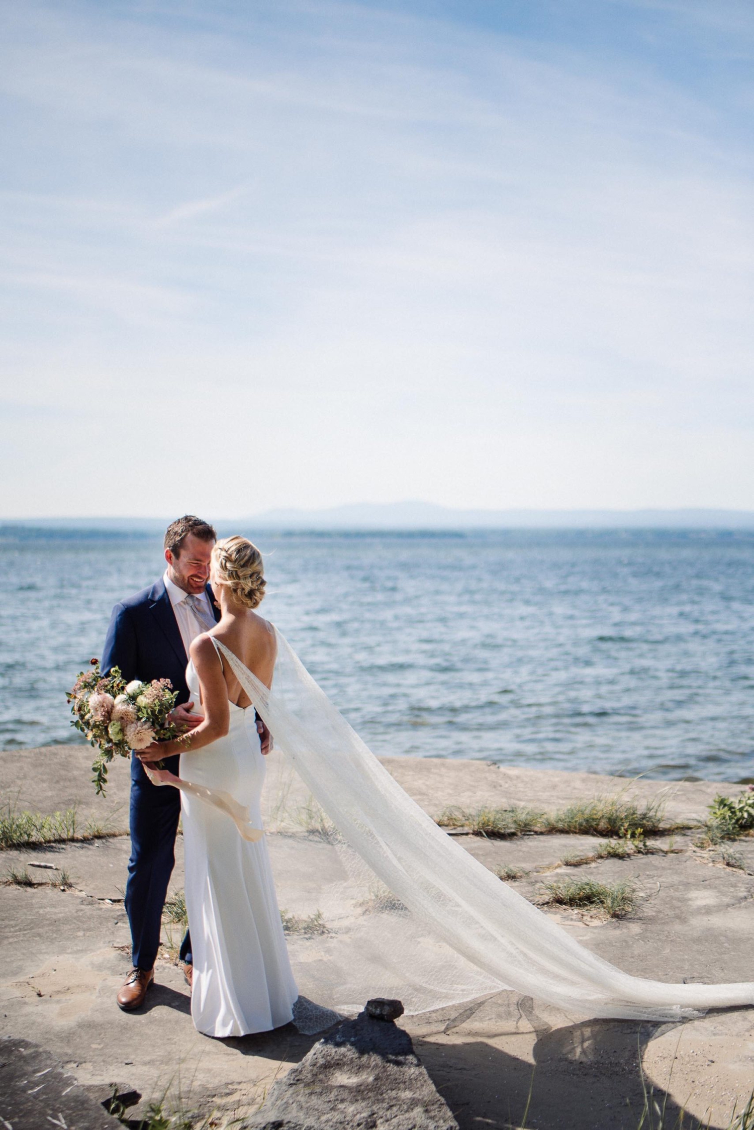 Bride and groom pictures along the shore of Lake Champlain
