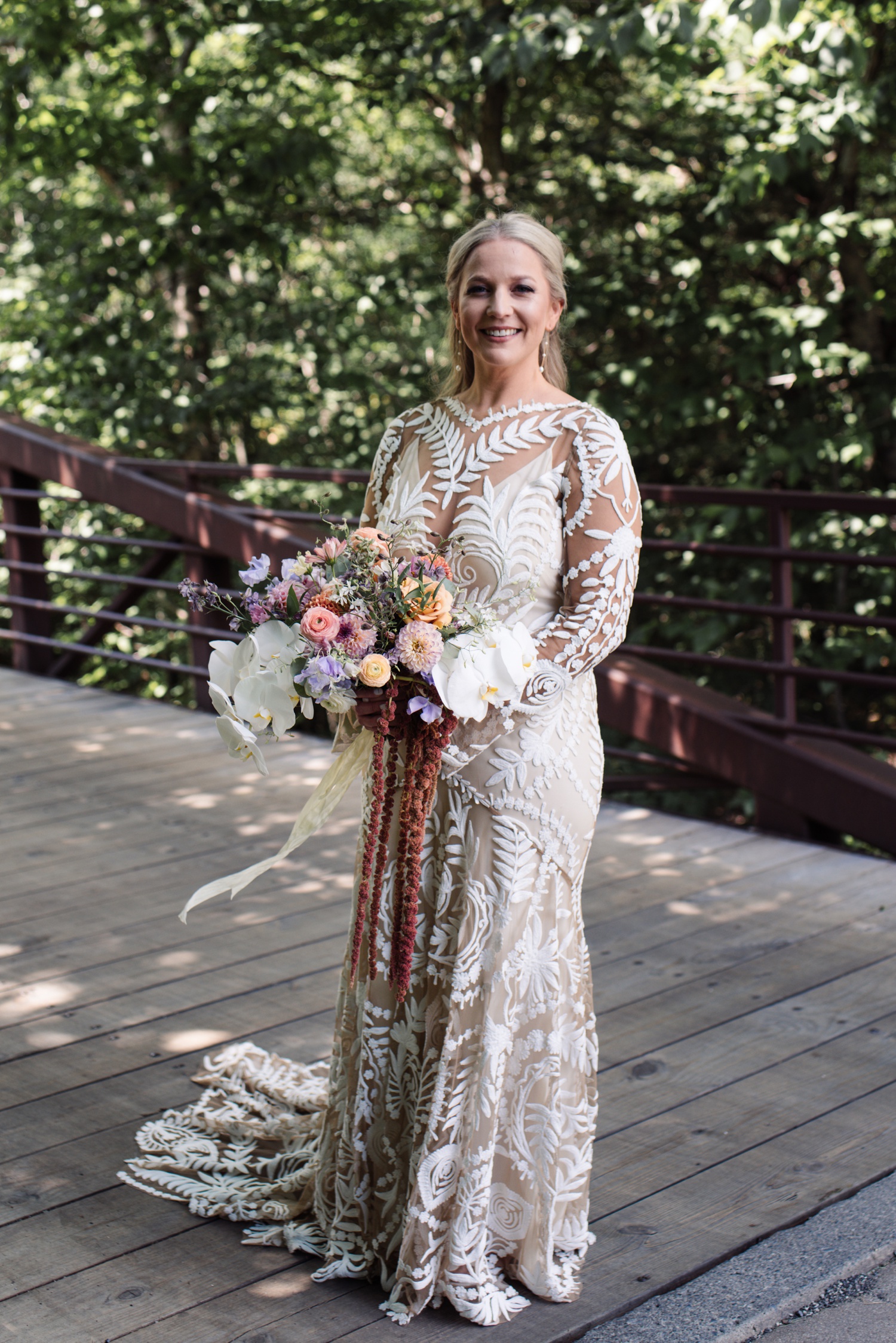 Bride in a long-sleeved wedding gown with lace cut-out details by Rue de Seine