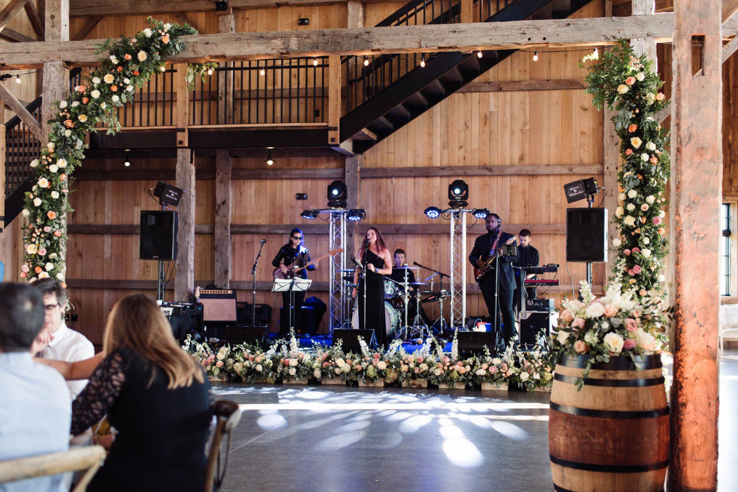 Men in Black wedding musicians perform at Maquam Barn and Winery with floral arches by Clayton Floral