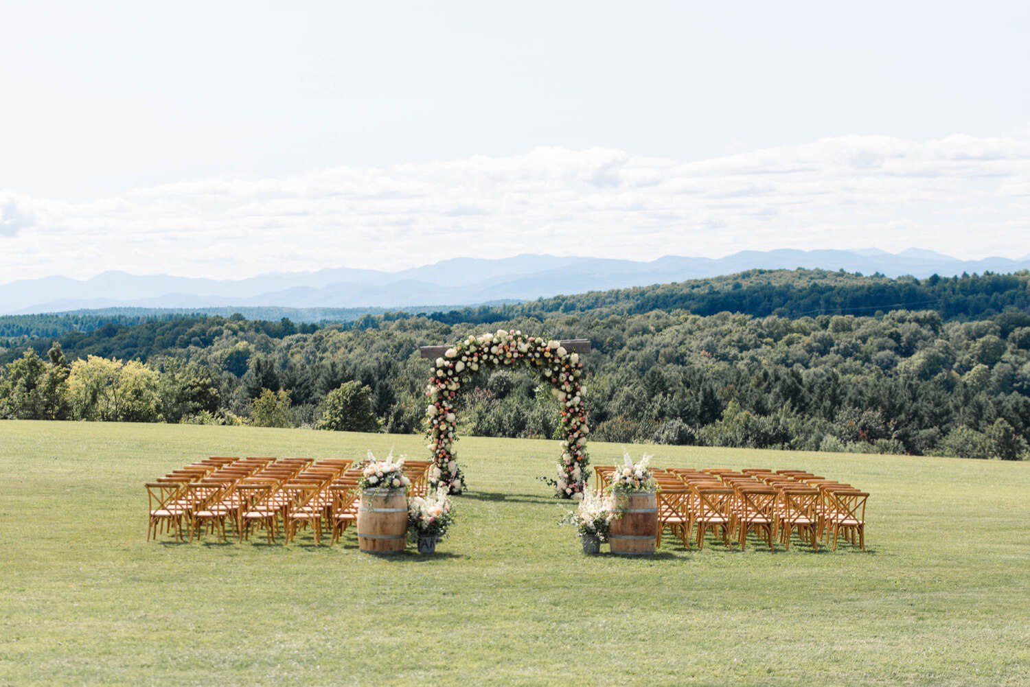 Empty chairs and arbor overlooking the Adirondacks at Maquam Barn and Winery