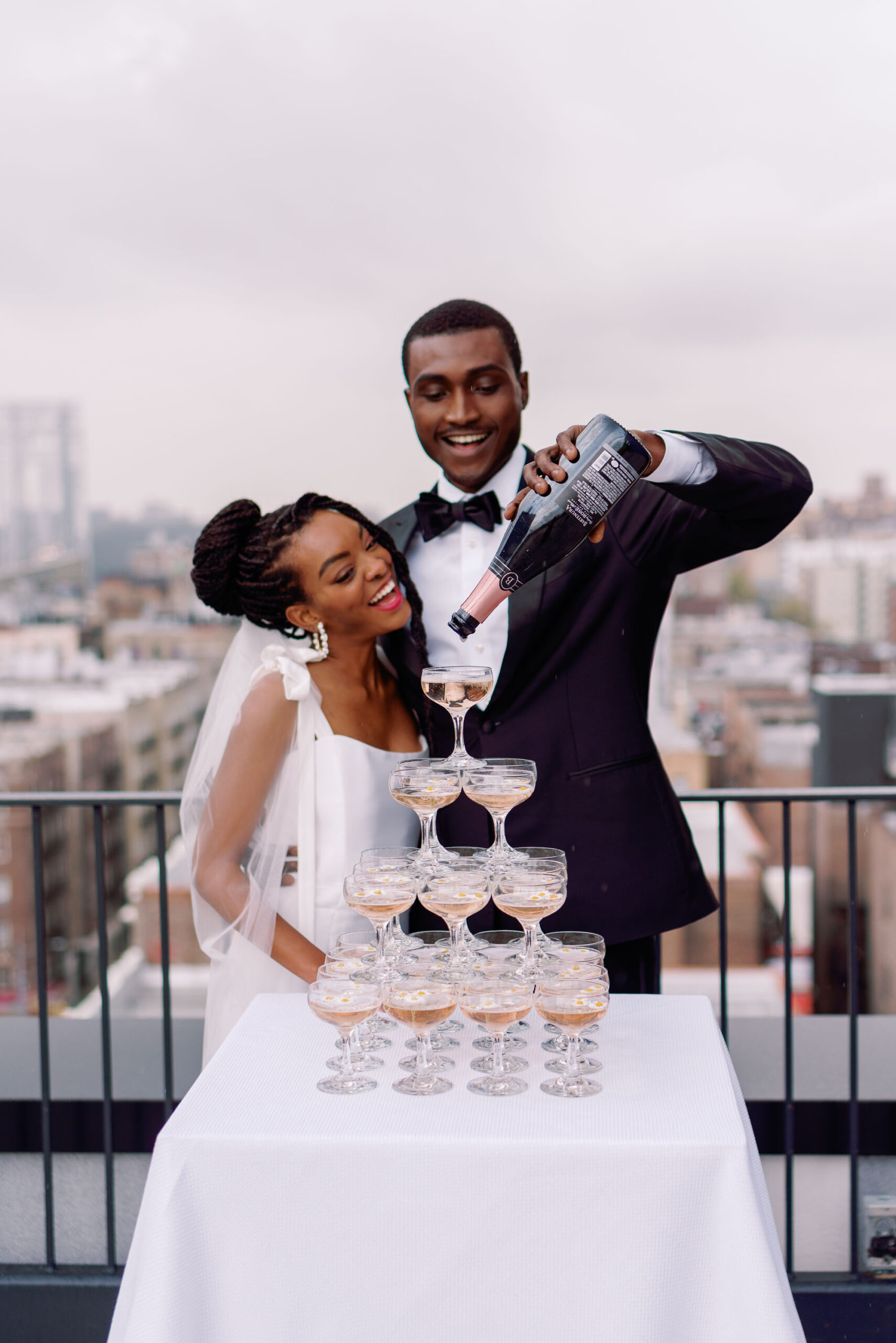 above the heights nyc wedding venue with couple pouring champagne