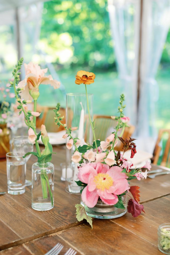 colorful pink summer wedding flowers at tented wedding reception in vermont