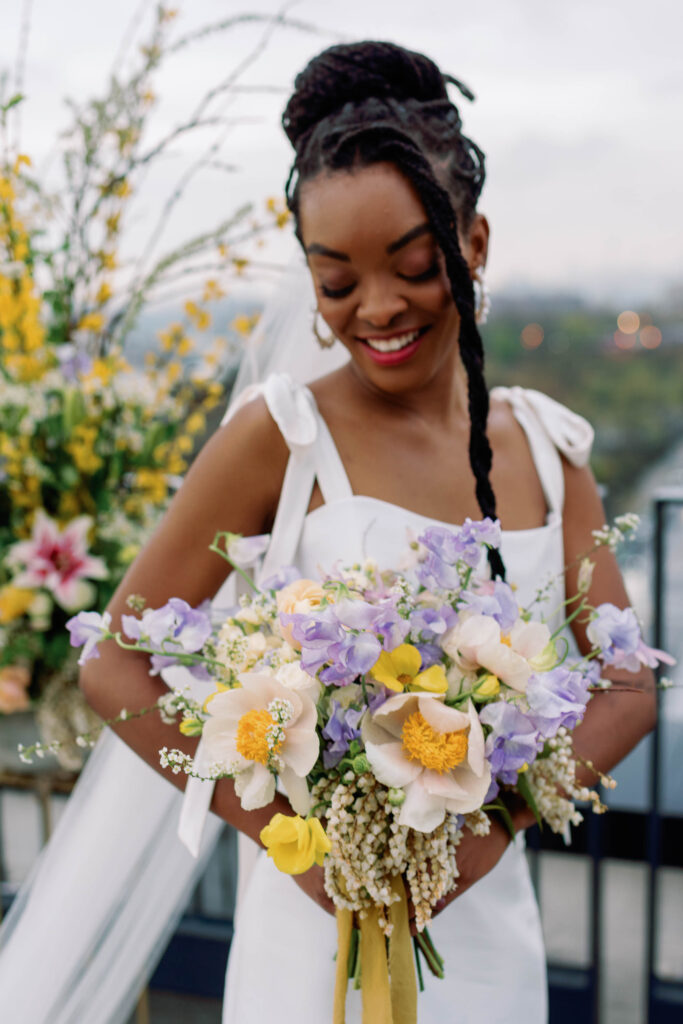 nyc spring bride in alexandra grecco mini dress and yellow bouquet of flowers