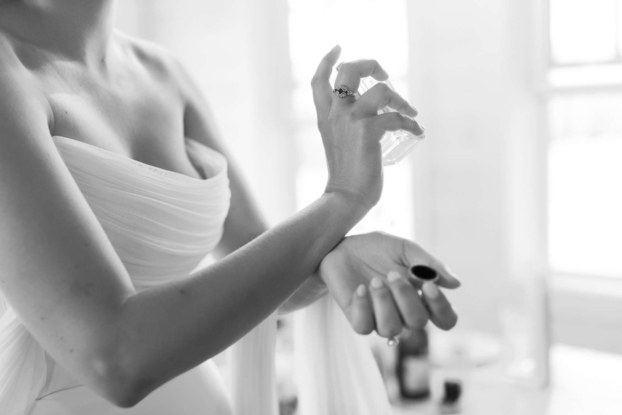 chic sarah seven bride applies perfume at vermont wedding