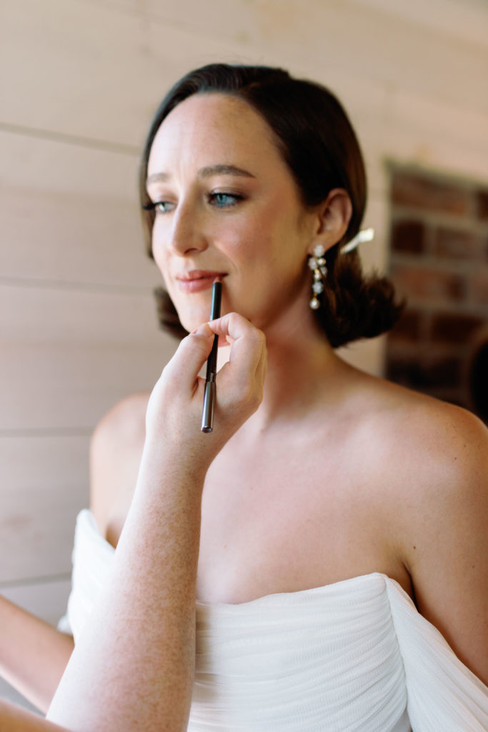 sarah seven bride has lip liner applied by nellie marie artistry at vermont wedding