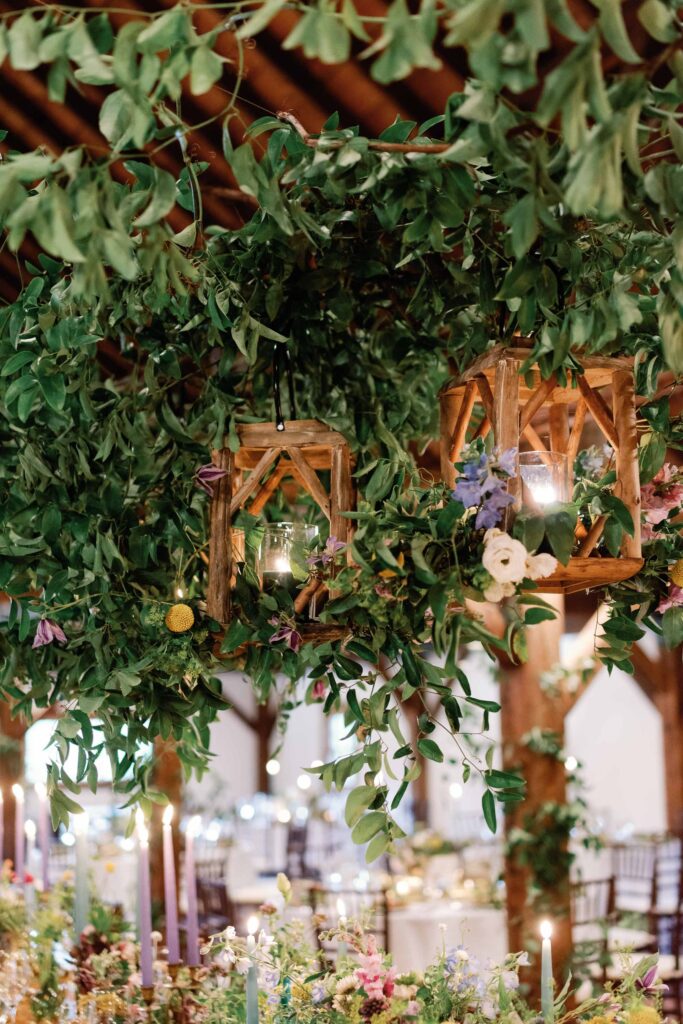 hanging lantern installation for magical floral forest installation at barn at riverside farm vt wedding