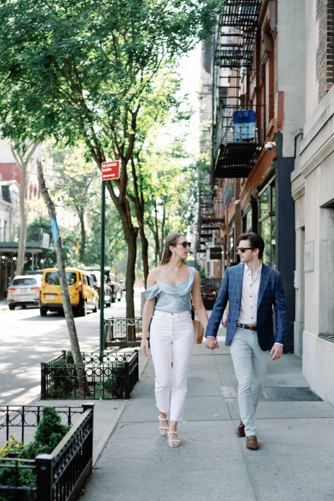 chic nyc west village engagement session couple walks in neighborhood with yellow cab in the background