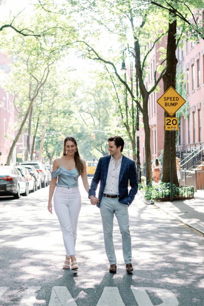 west village engagement session outfits on display as couple walks down dappled lit street