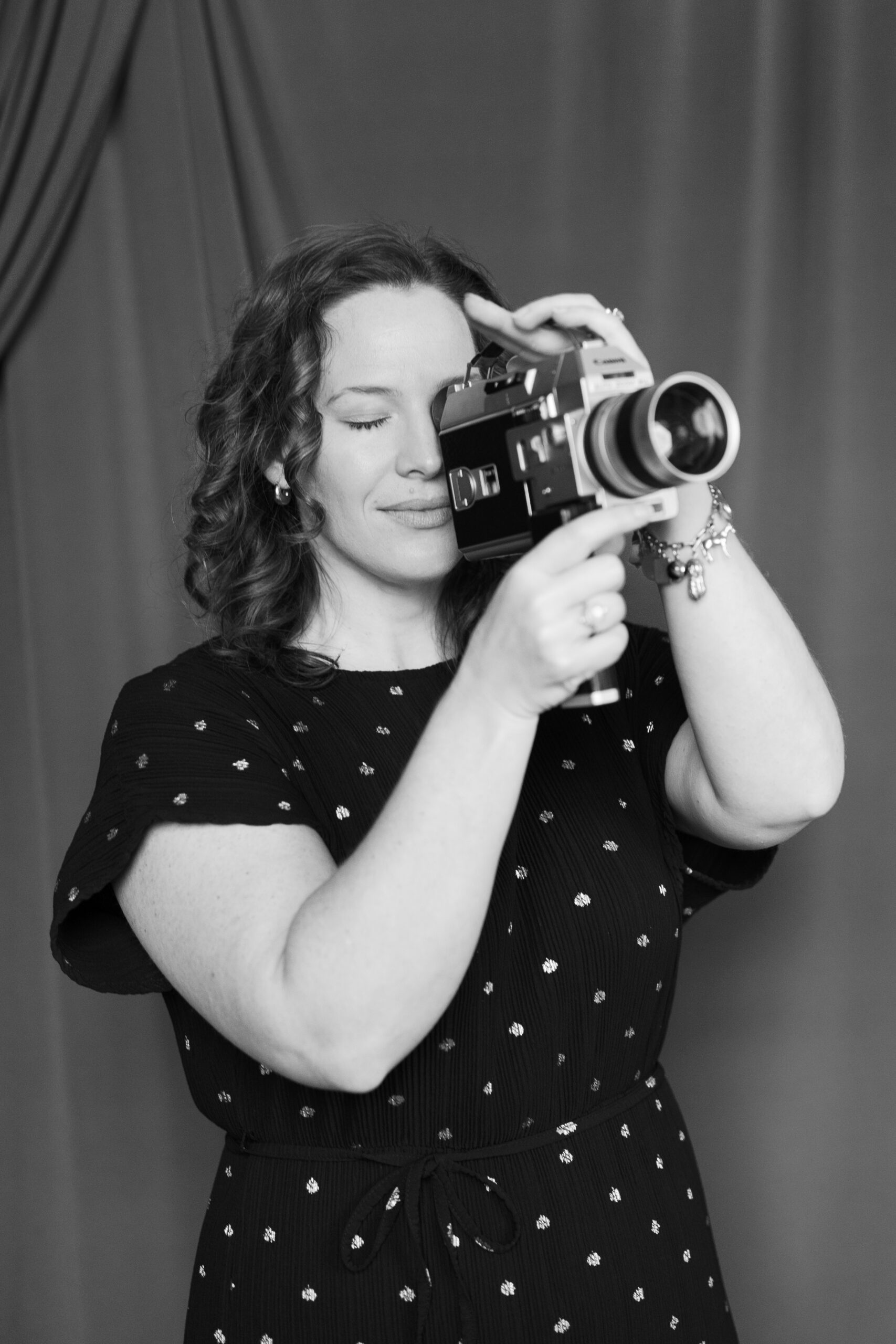 image of Julia Luckett, vermont wedding photographer, holding vintage super 8 film camera